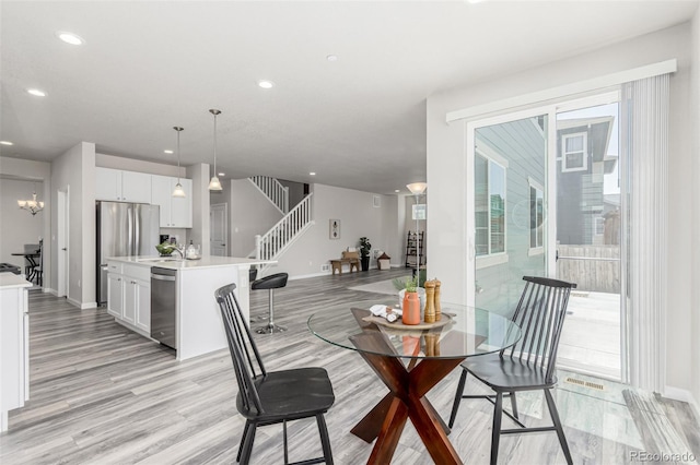 12941 Delaware St, Westminster, CO 80234 - dining space with light wood-type flooring, recessed lighting, baseboards, and stairway