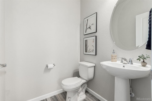 12941 Delaware St, Westminster, CO 80234 - bathroom featuring wood finished floors, toilet, baseboards, and a sink