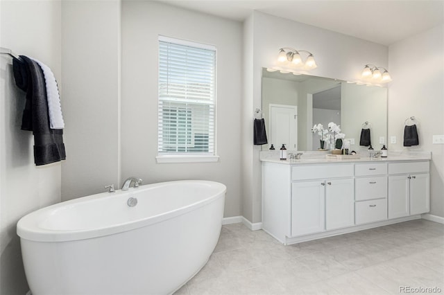 12941 Delaware St, Westminster, CO 80234 - full bathroom featuring double vanity, a freestanding tub, and baseboards