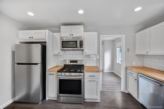 1801 S Eudora St, Denver, CO 80222 - kitchen featuring appliances with stainless steel finishes, wooden counters, white cabinets, baseboards, and tasteful backsplash