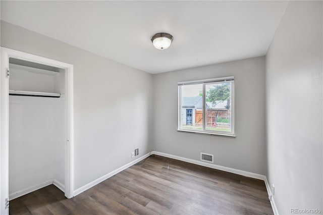 1801 S Eudora St, Denver, CO 80222 - unfurnished bedroom featuring baseboards, dark wood-style floors, and a closet