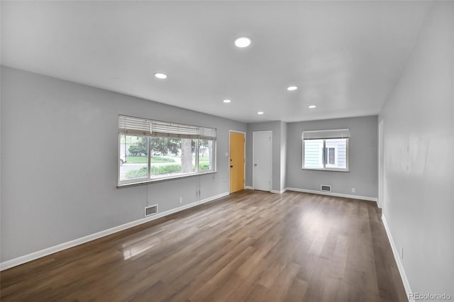 1801 S Eudora St, Denver, CO 80222 - unfurnished living room with healthy amount of natural light, recessed lighting, wood finished floors, and baseboards