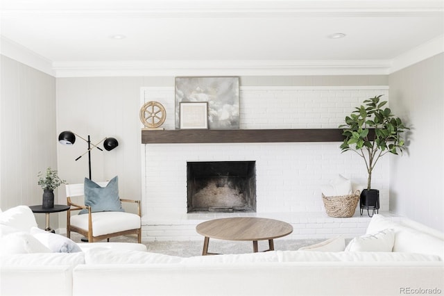 living area with ornamental molding and a fireplace