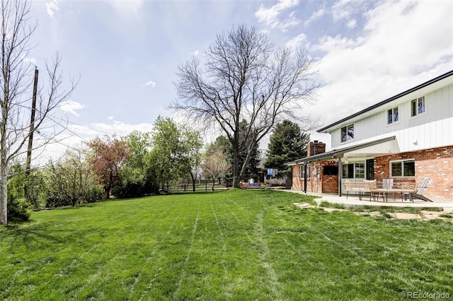 view of yard with fence and a patio area