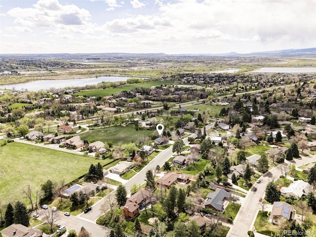 drone / aerial view featuring a water view and a residential view