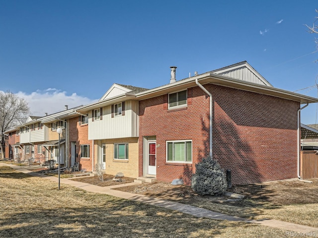 back of house featuring entry steps and brick siding