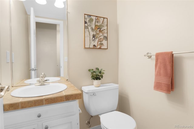 bathroom featuring vanity and toilet