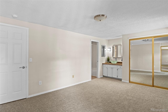 carpeted spare room with a textured ceiling