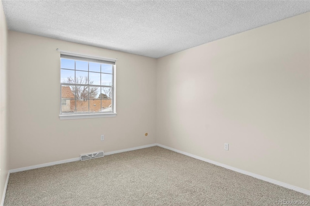 unfurnished room with carpet floors and a textured ceiling