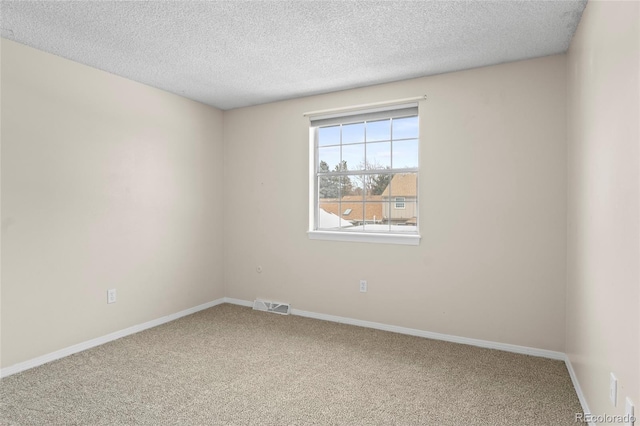 carpeted spare room with a textured ceiling