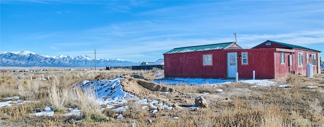 snow covered structure featuring a mountain view