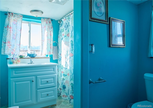 bathroom featuring vanity and toilet