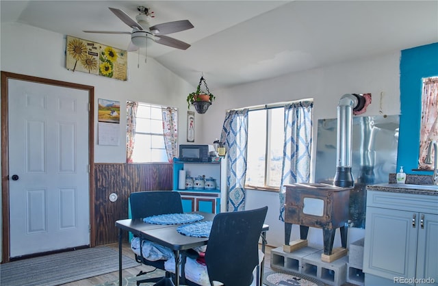 dining room featuring lofted ceiling, hardwood / wood-style flooring, and ceiling fan