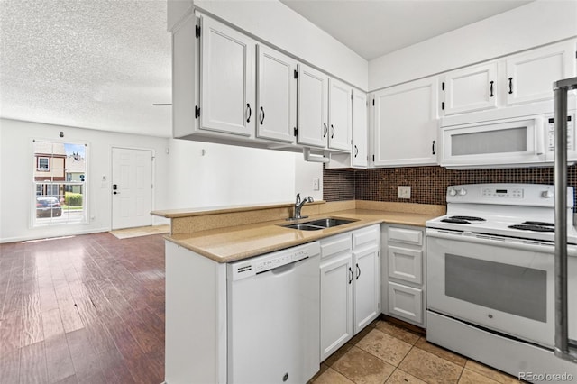14465 E Hawaii Cir Unit A, Aurora, CO 80012 - kitchen with white appliances, a sink, white cabinetry, and light countertops