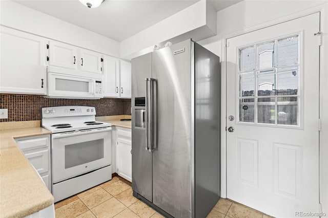 14465 E Hawaii Cir Unit A, Aurora, CO 80012 - kitchen with white appliances, light countertops, white cabinetry, and light tile patterned floors