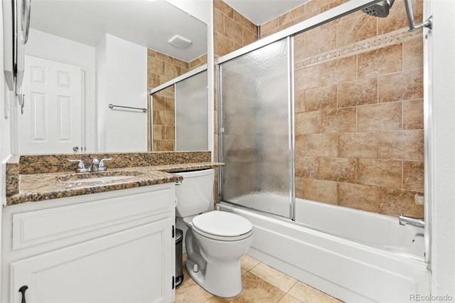 14465 E Hawaii Cir Unit A, Aurora, CO 80012 - full bathroom with toilet, vanity, bath / shower combo with glass door, and tile patterned flooring