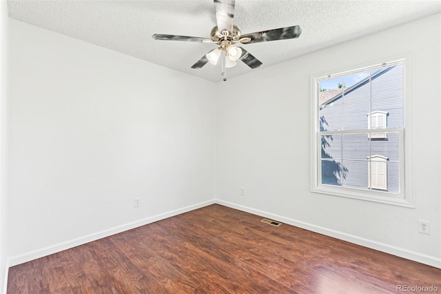 14465 E Hawaii Cir Unit A, Aurora, CO 80012 - spare room featuring dark wood-style flooring, baseboards, a textured ceiling, and a ceiling fan