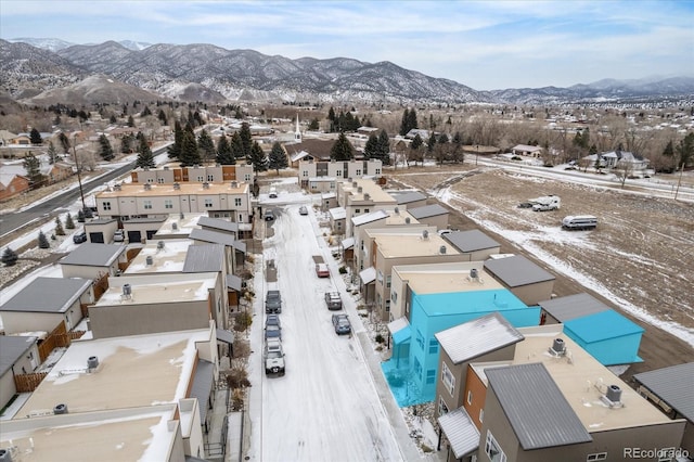 snowy aerial view with a mountain view