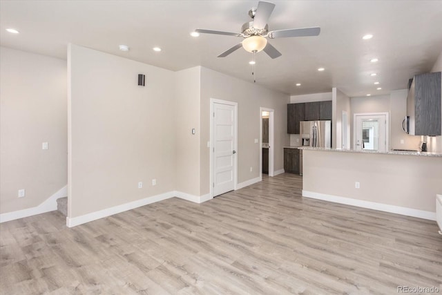 unfurnished living room with ceiling fan and light hardwood / wood-style flooring