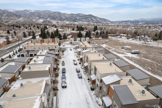 snowy aerial view featuring a mountain view