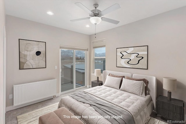 carpeted bedroom with baseboards, radiator heating unit, recessed lighting, and access to exterior