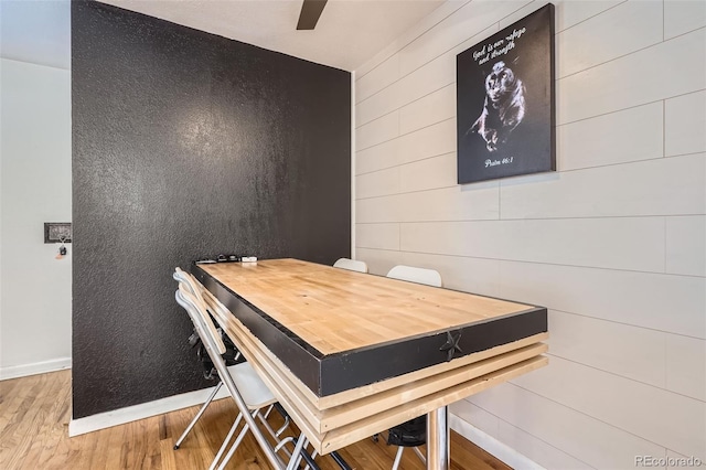 5184 E Asbury Ave, Denver, CO 80222 - dining area featuring wood finished floors, baseboards, and wood walls