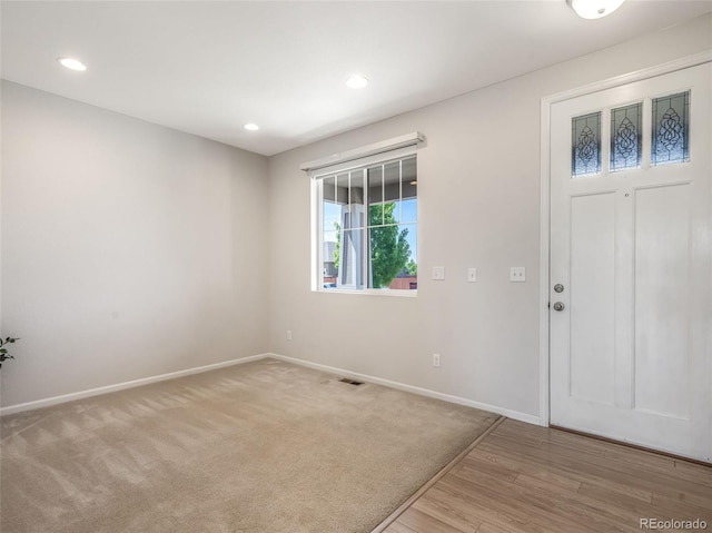 foyer entrance with light carpet