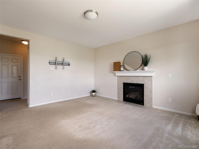 unfurnished living room with a tile fireplace and carpet flooring