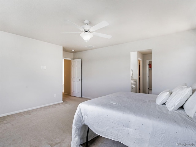 carpeted bedroom with ceiling fan and ensuite bath