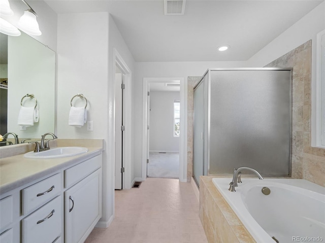 bathroom featuring vanity and shower with separate bathtub