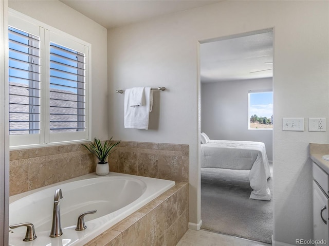 bathroom featuring vanity and tiled tub