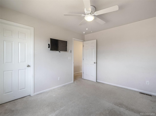 unfurnished bedroom featuring light carpet and ceiling fan