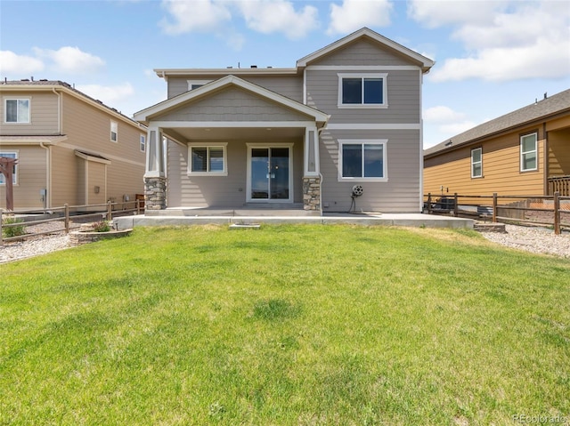 rear view of property with a yard