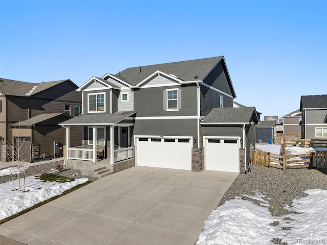 view of front of property with covered porch and a garage