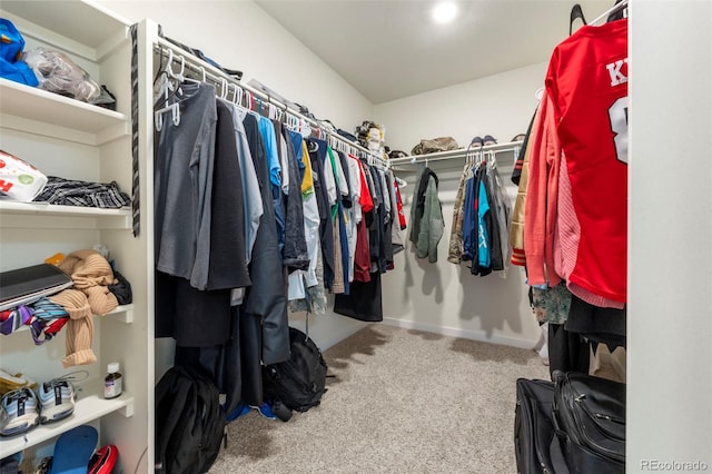 walk in closet with carpet