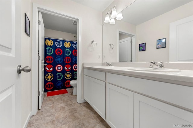 bathroom featuring vanity and toilet