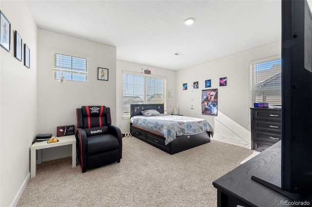 bedroom featuring light carpet