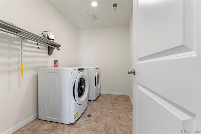 washroom with independent washer and dryer