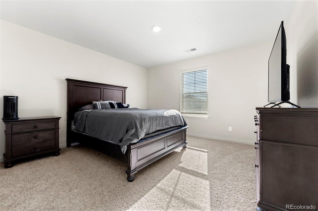 bedroom with light colored carpet