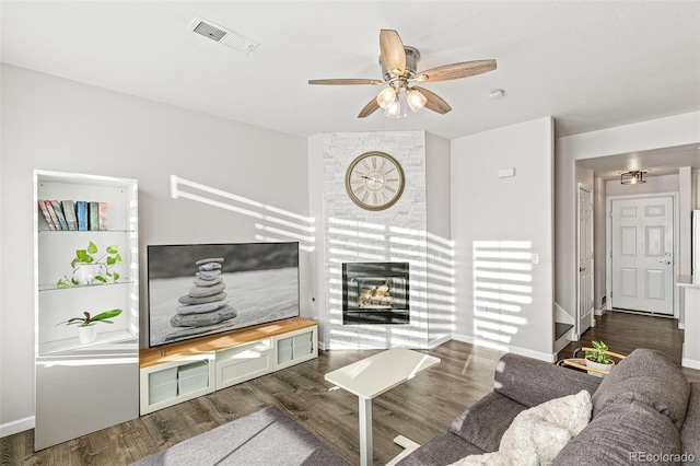 living room with ceiling fan and dark hardwood / wood-style floors