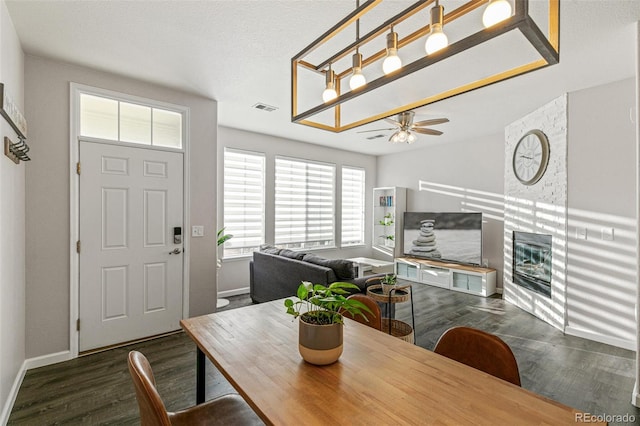 dining area with ceiling fan and dark hardwood / wood-style flooring