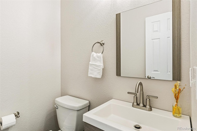 bathroom with toilet and vanity