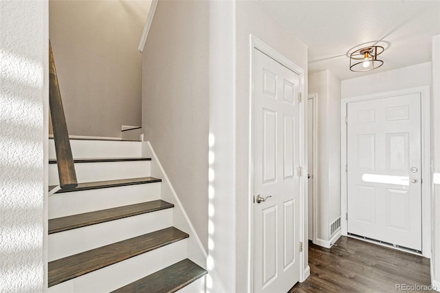 staircase with hardwood / wood-style flooring