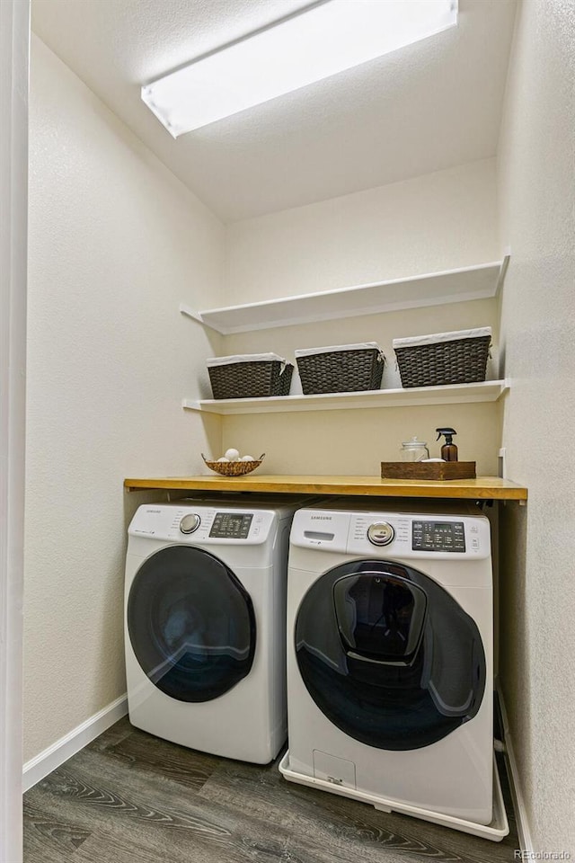 laundry room featuring dark wood-type flooring and separate washer and dryer