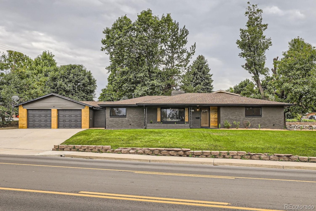 ranch-style home featuring a front yard and a garage