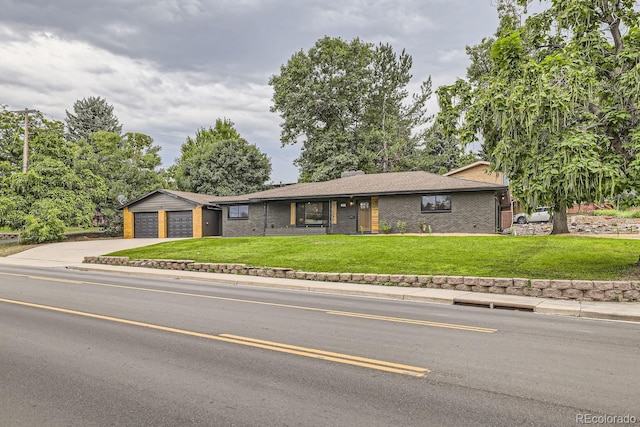 ranch-style home featuring a garage and a front lawn