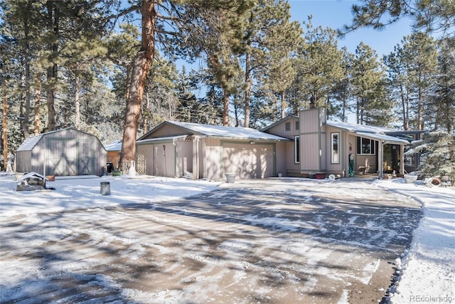 view of snowy exterior featuring a shed