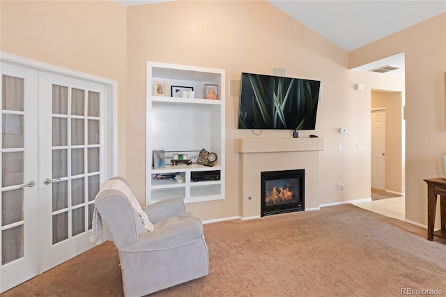 sitting room with carpet, french doors, and vaulted ceiling