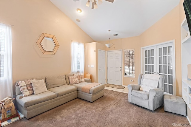 living room featuring carpet floors, lofted ceiling, french doors, and a healthy amount of sunlight