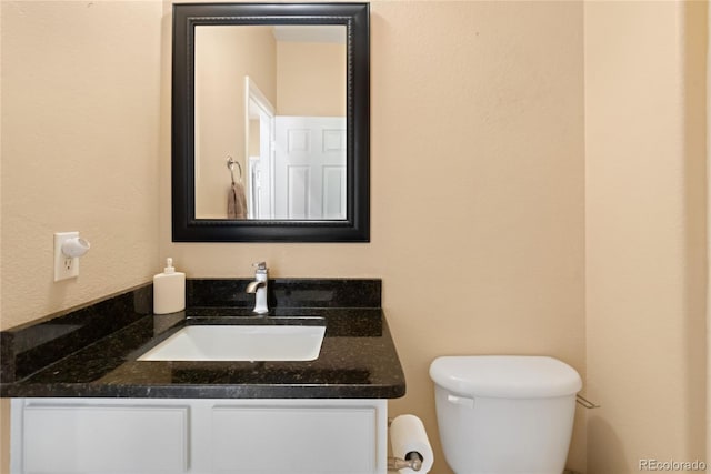 bathroom with toilet and vanity